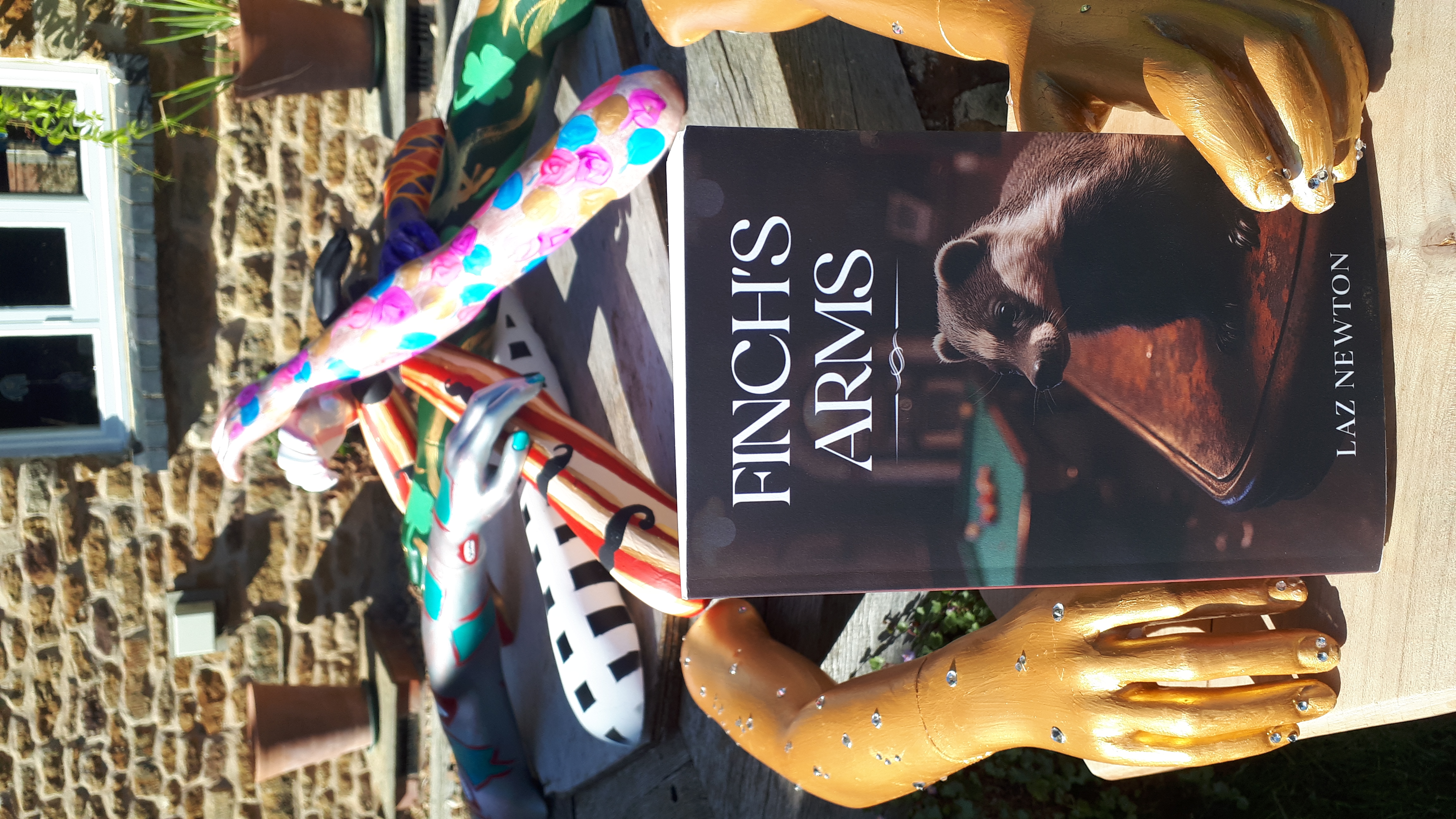 Finch's Arms held by mannequin hands